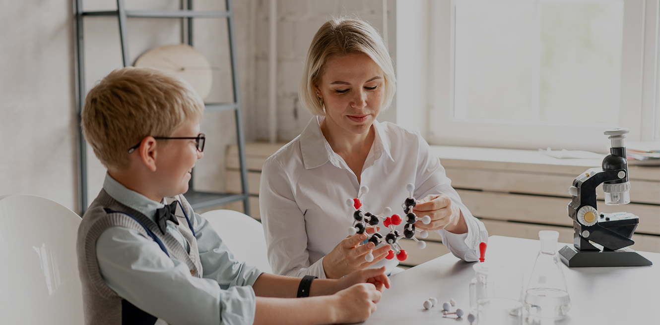 Female science tutor in Sacramento studying chemistry with student